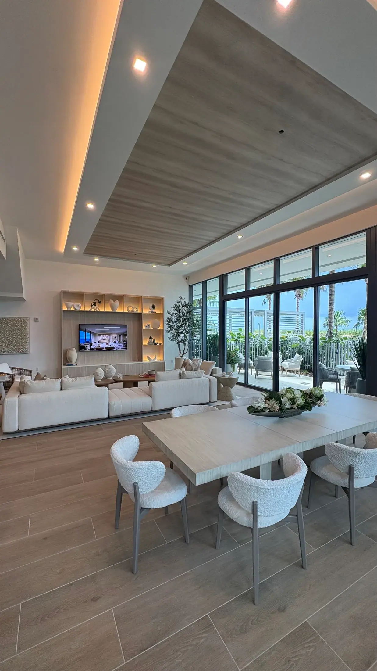Living and dining in one room with a lit niche wall