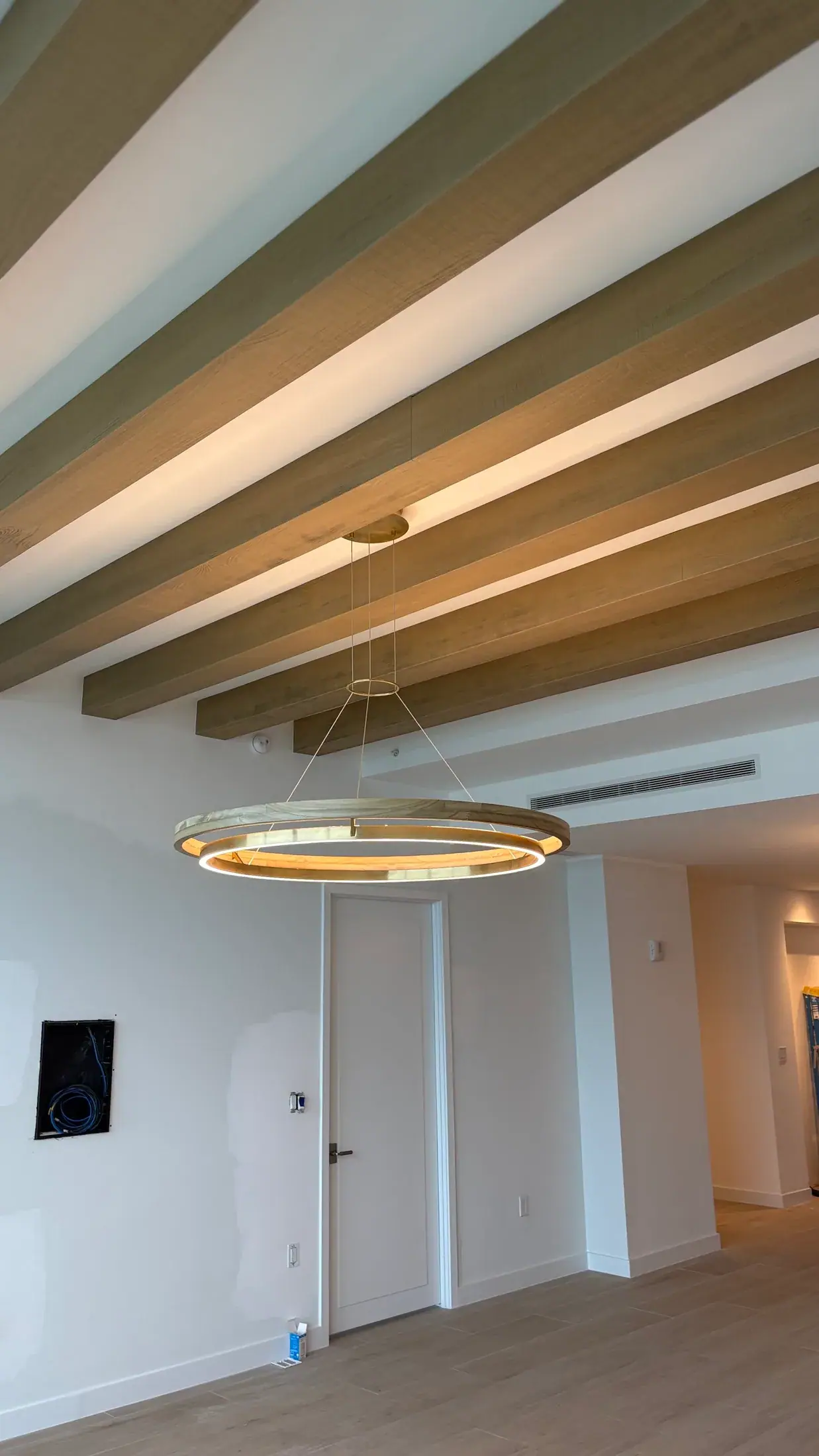 Exposed wood beams with a ring fixture hung from the centre