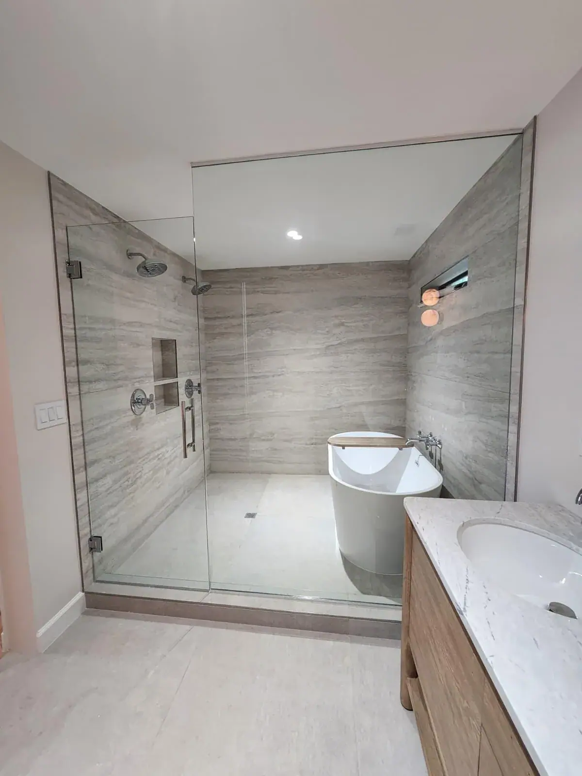 Shower and freestanding tub sharing one glazed enclosure
