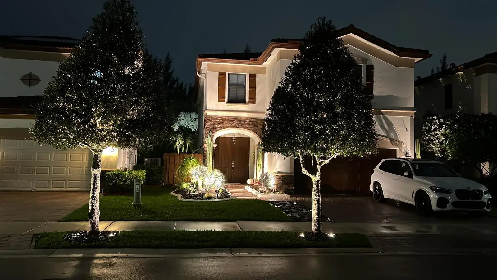 Exterior lighting: uplights on the trees and bollards on the path