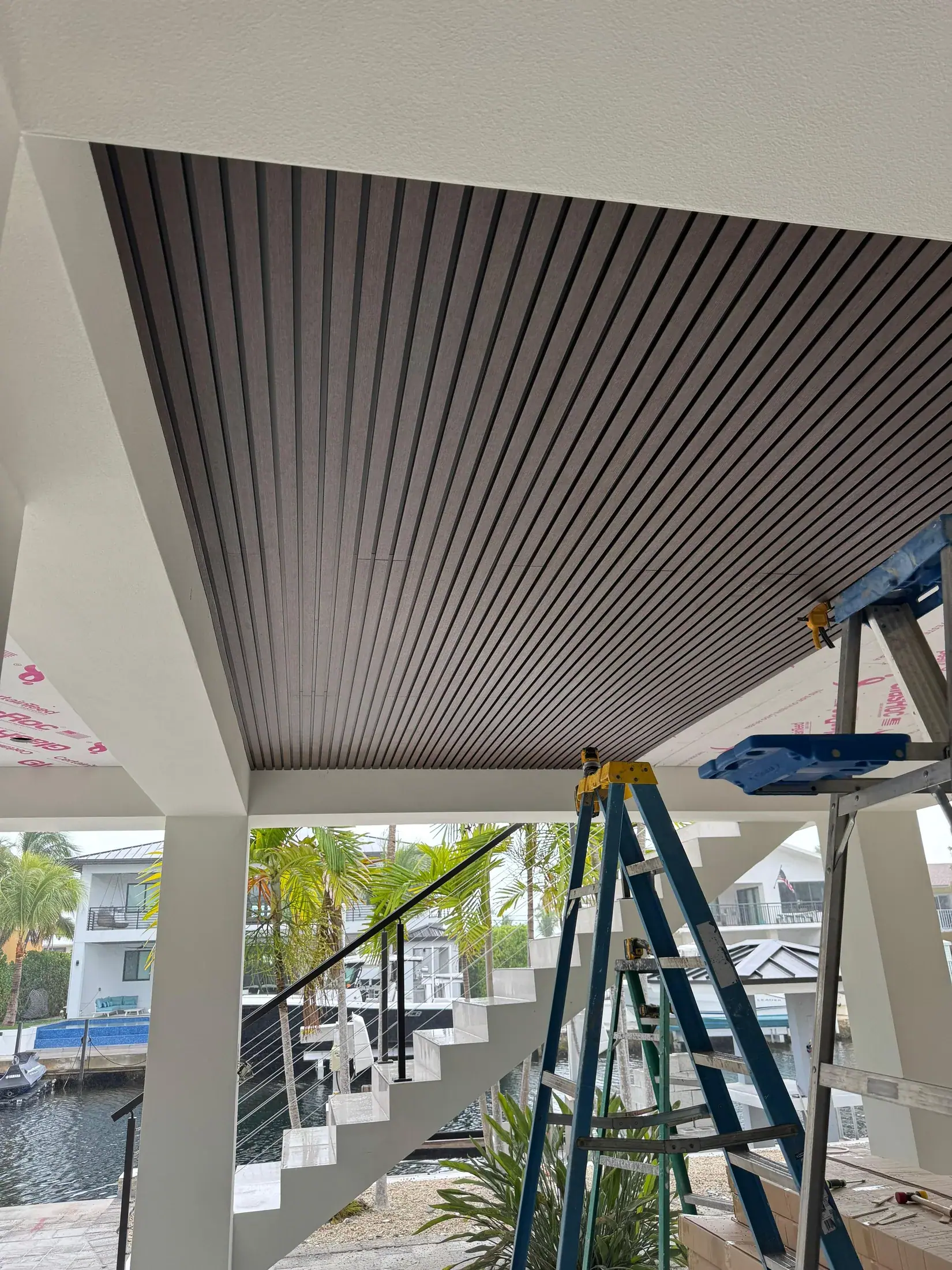 Slat ceiling mid-installation, with access towers in place